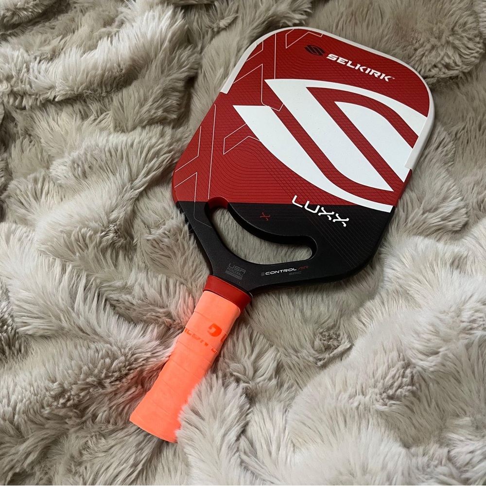 Red and black pickleball paddle.